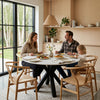 Round Fiorella 120 cm table in Clay – setting with a family having dinner