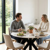 Round Fiorella 120 cm table in Travertine – setting with two people having lunch