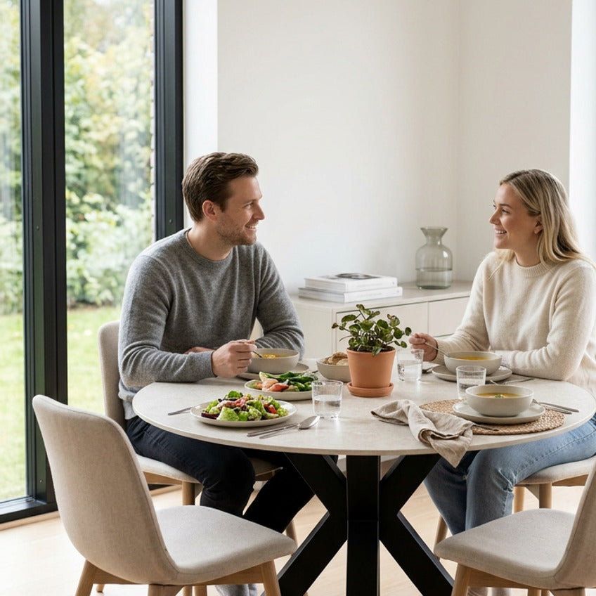 Round Fiorella 120 cm table in Travertine – setting with two people having lunch